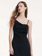 a lady in black asymmetrical strap dress